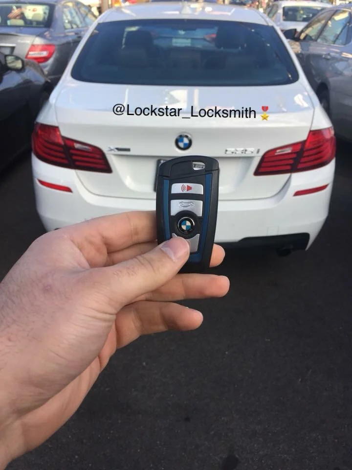 BMW key fob beside a white BMW