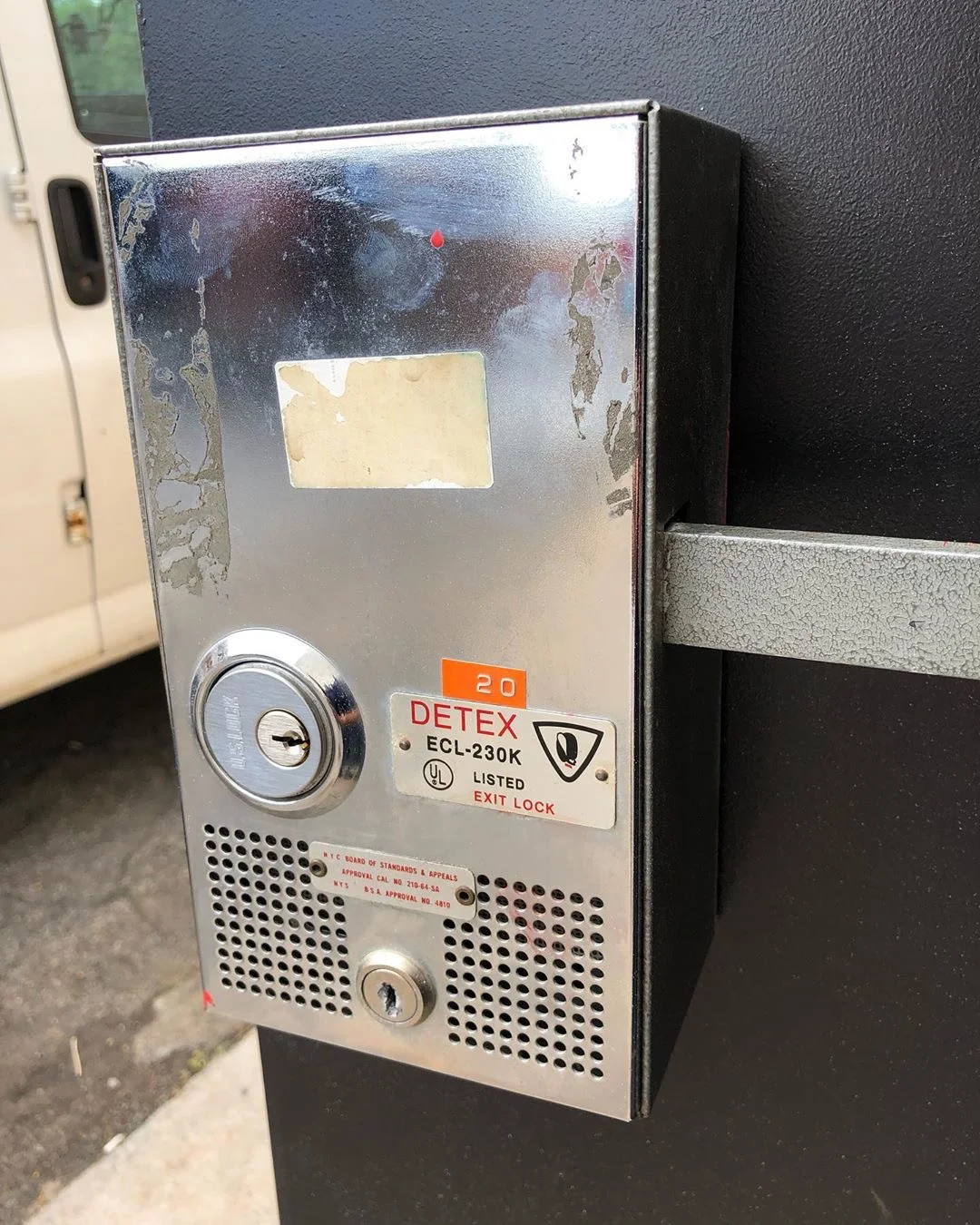 Detex alarmed exit lock on a metal door